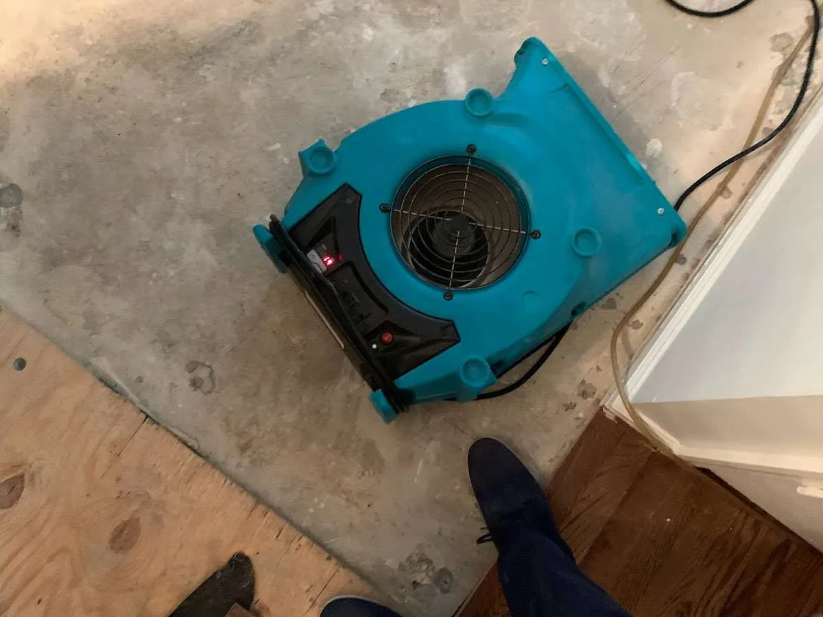 Air mover drying subfloor during Commercial Water Damage Restoration in Bennington